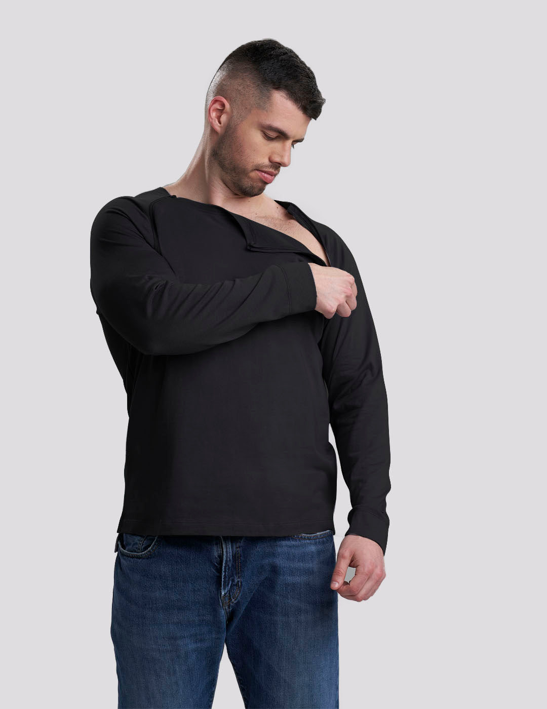 Sleek Black Men&#39;s Chest Port Access Shirt by Care+Wear, combining style with practical design for healthcare professionals. Model is wearing size Large