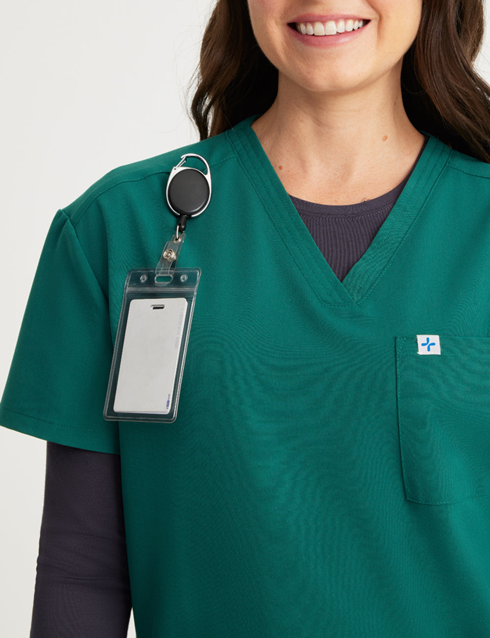 Durable and comfortable hunter green V-neck scrub top for women, ideal for professional settings