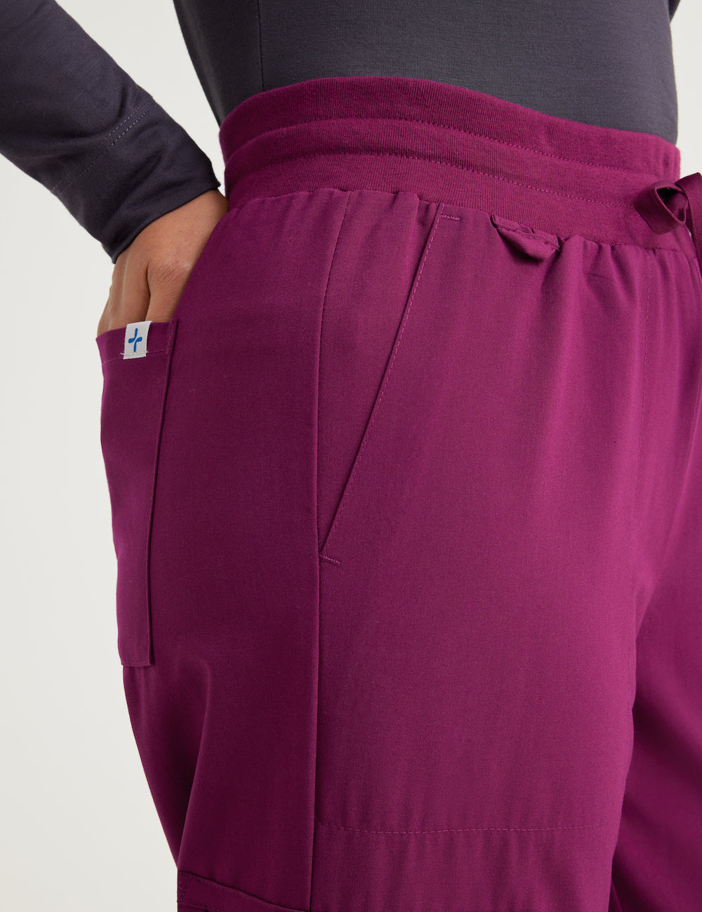Burgundy women's scrub jogger pants with 12 pockets, combining style and utility for professional wear