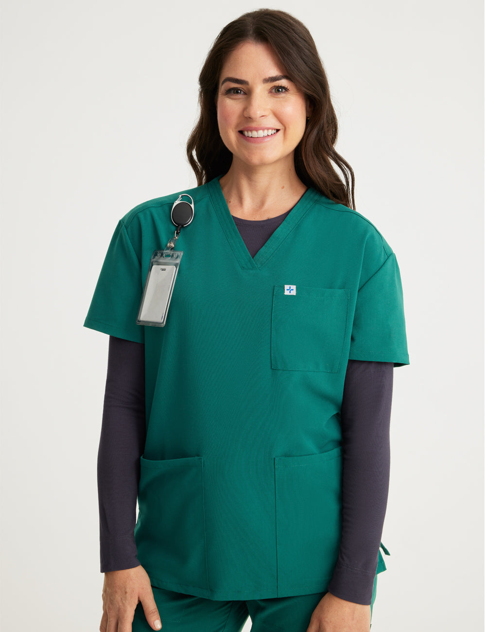 Hunter green women's V-neck scrub top with three pockets, combining practicality and a rich color