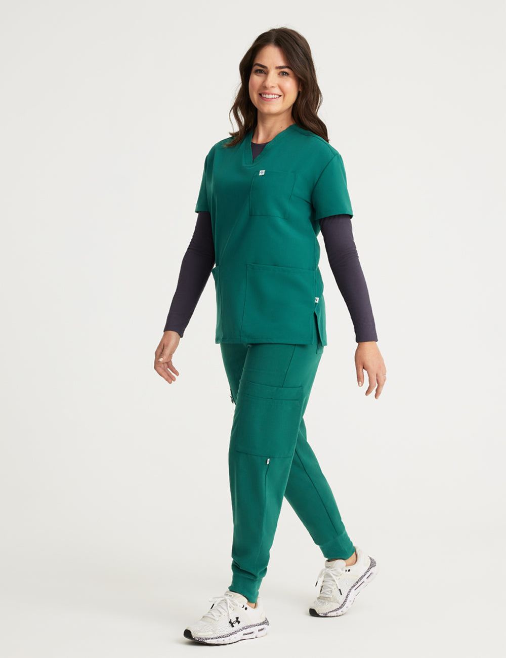 Hunter green women's V-neck scrub top with three pockets, combining practicality and a rich color