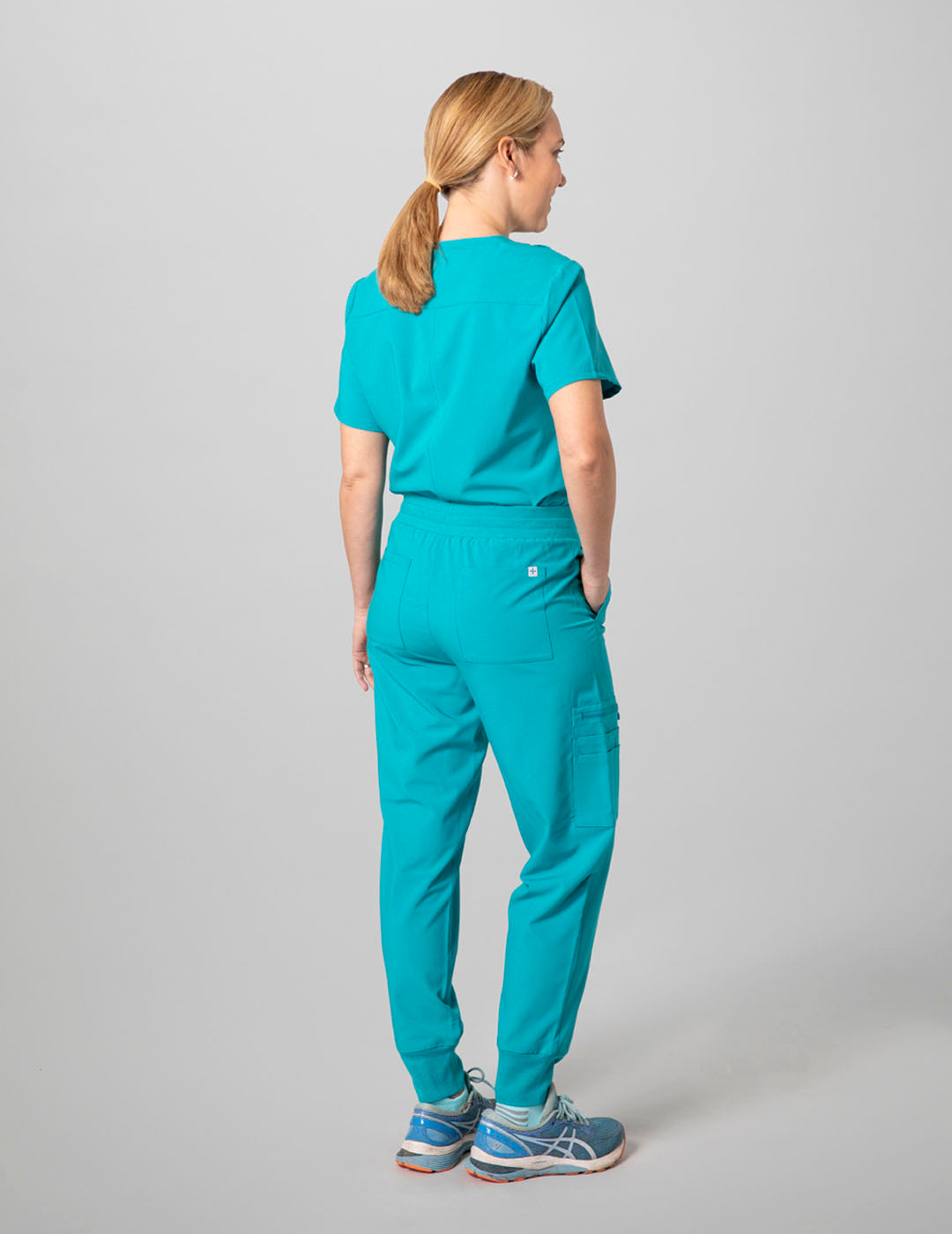 Stylish teal scrub top for women, combining a two-pocket layout with a modern V-neck cut