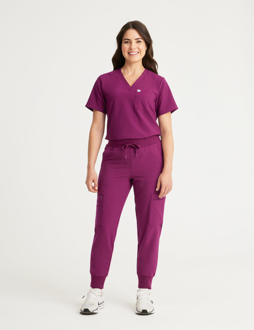 Stylish burgundy scrub top for women, combining a classic V-neck cut with a two-pocket design