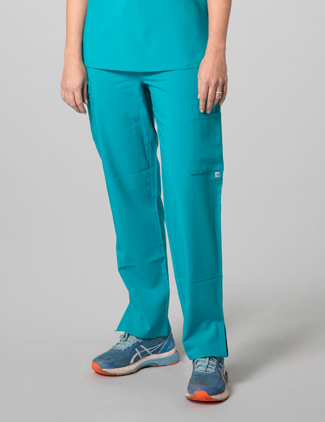 Teal women's straight-leg scrub pants with nine pockets, offering style and utility