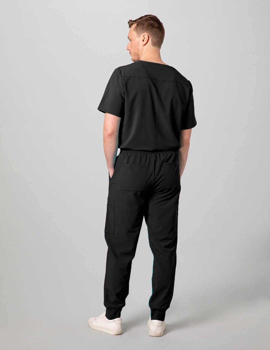 Professional men's V-neck scrub top in black, offering a timeless look with practical storage options.
