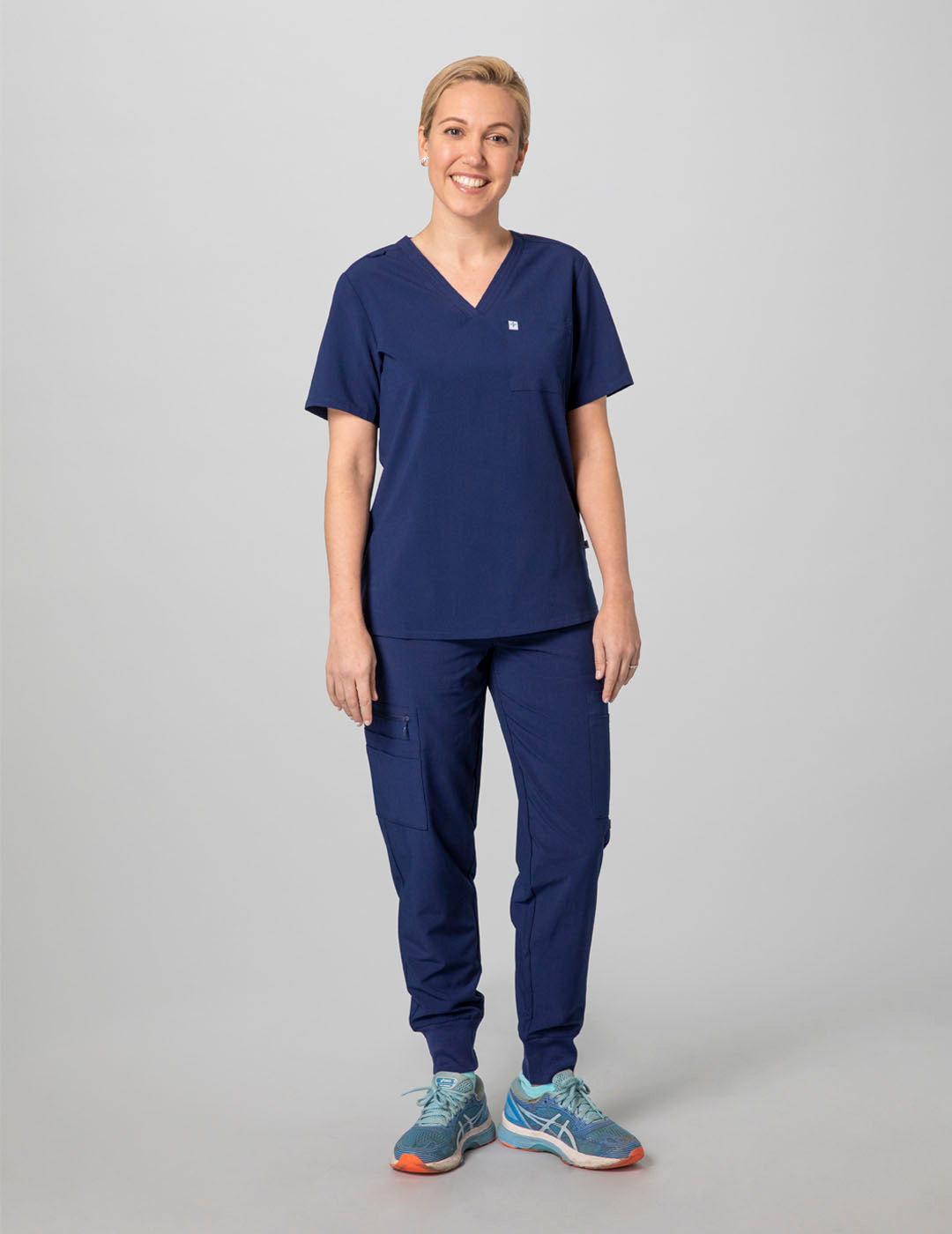 Women's scrub top in navy, featuring a sleek V-neck design and two practical pockets