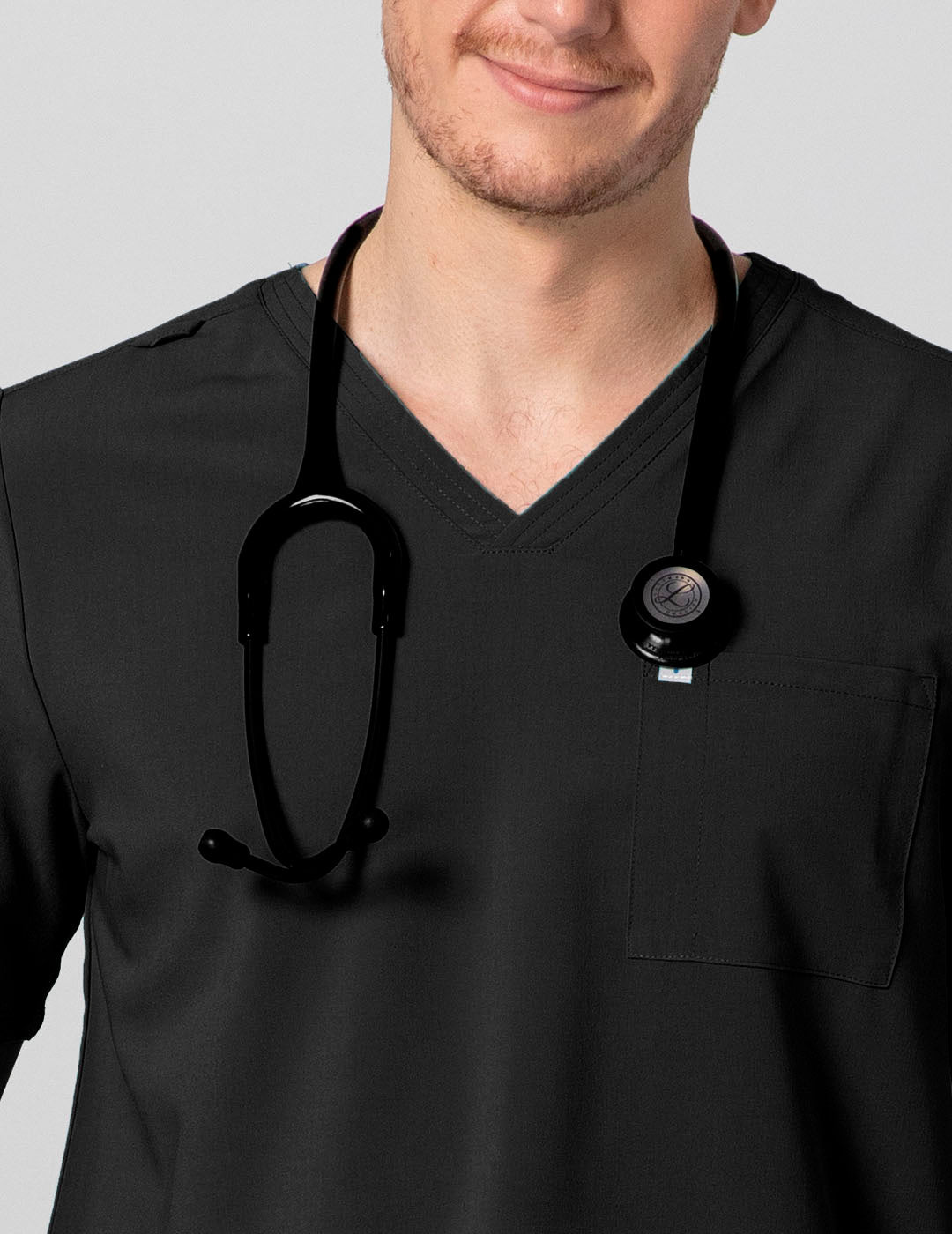 Men's scrub top in black, featuring a classic V-neck style and two pockets for functional storage.