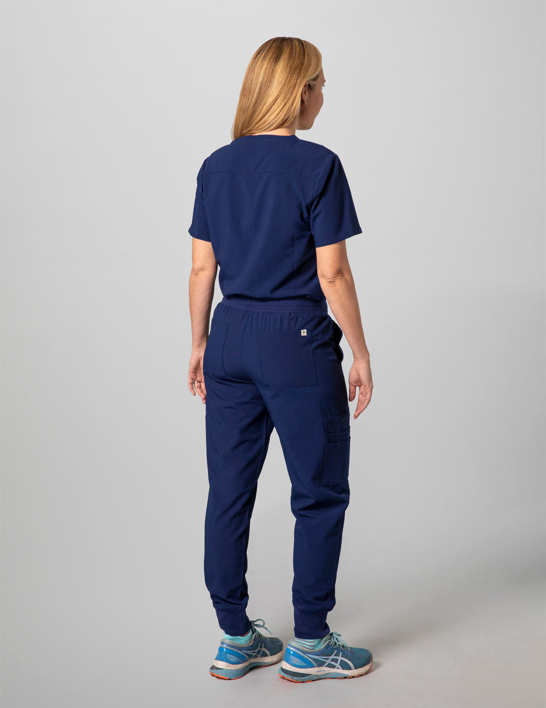 Stylish navy scrub top for women, offering a two-pocket layout and timeless V-neck style