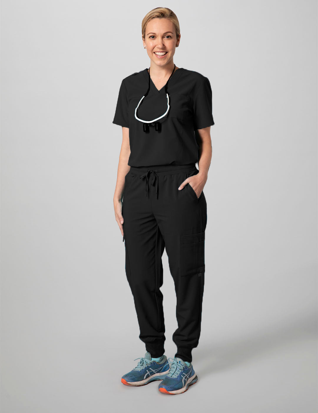 Women's scrub top in black, featuring a classic V-neck style and two practical pockets
