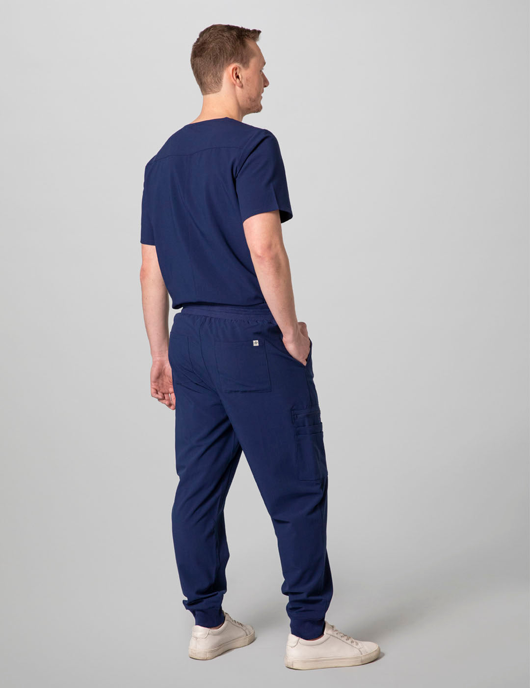 Stylish navy scrub top for men, designed with two pockets and a classic V-neck cut