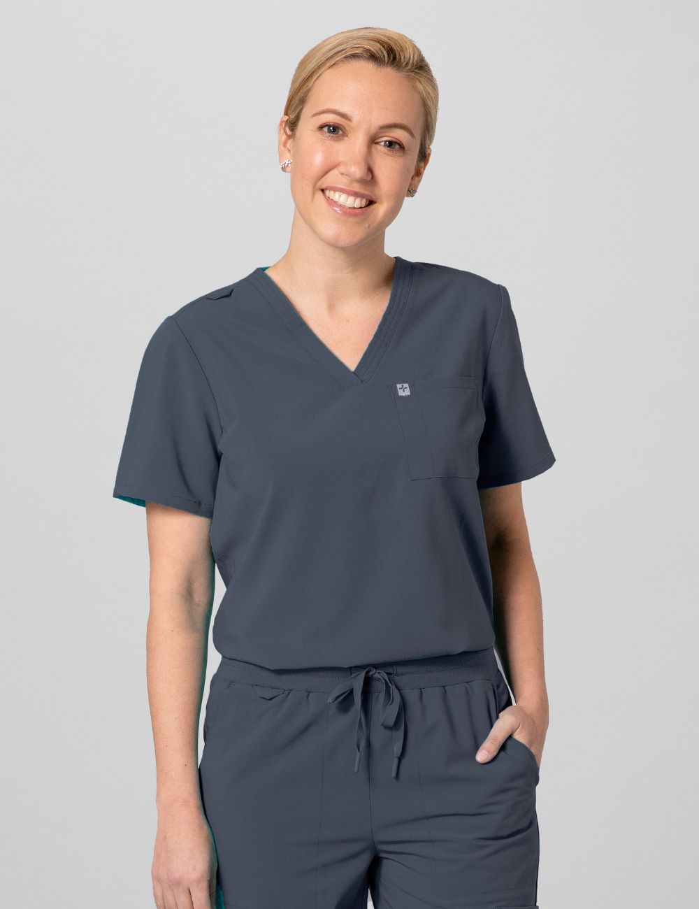 Pewter women's V-neck scrub top with two pockets, offering a sleek and functional design