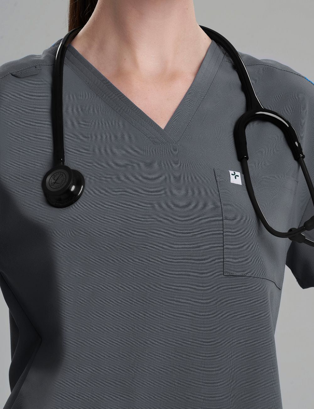 Stylish pewter scrub top for women, combining a two-pocket layout with a modern V-neck design