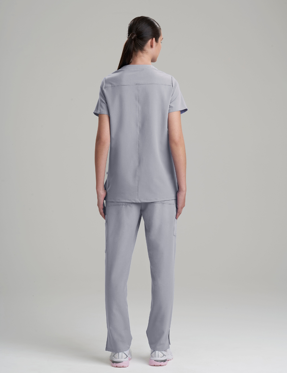 Modern stone gray scrub top for women, combining a classic V-neck style with three convenient pockets