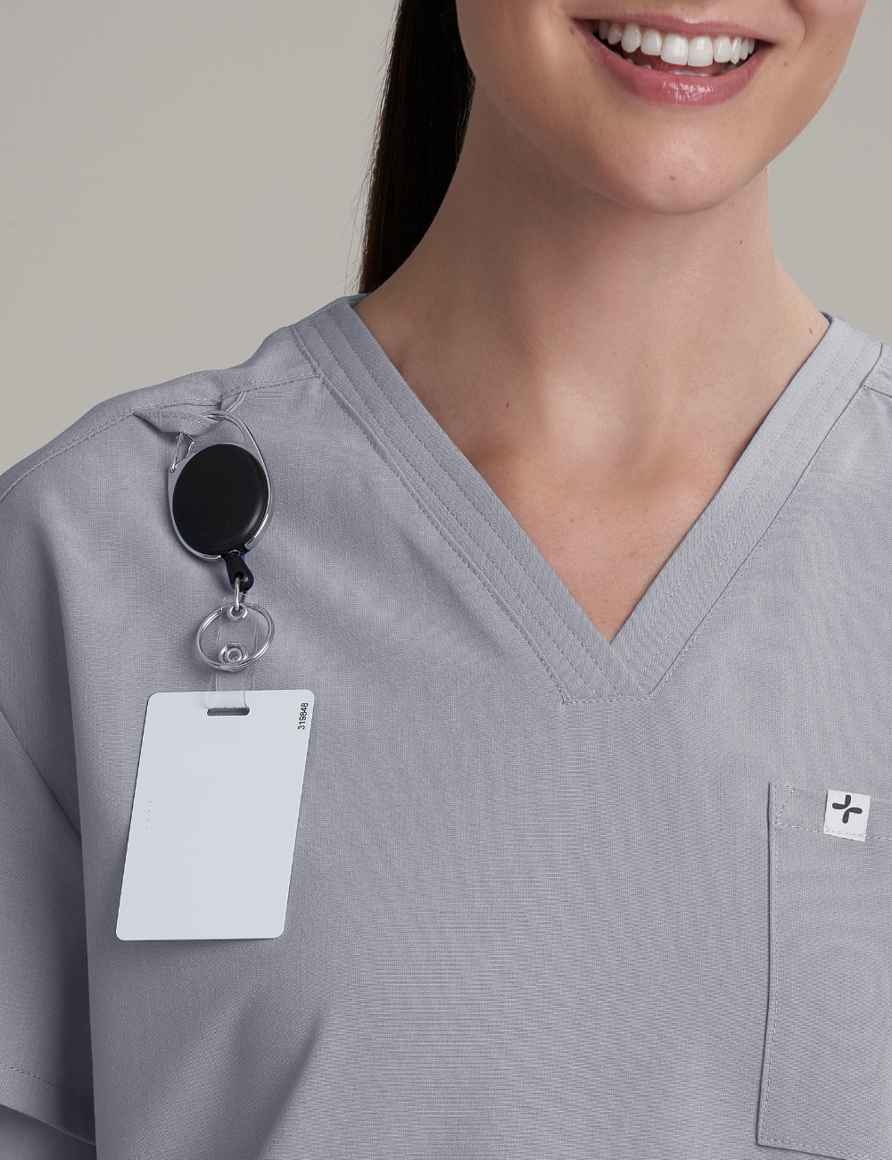 Stone gray women's V-neck scrub top with three pockets, designed for professional and practical use