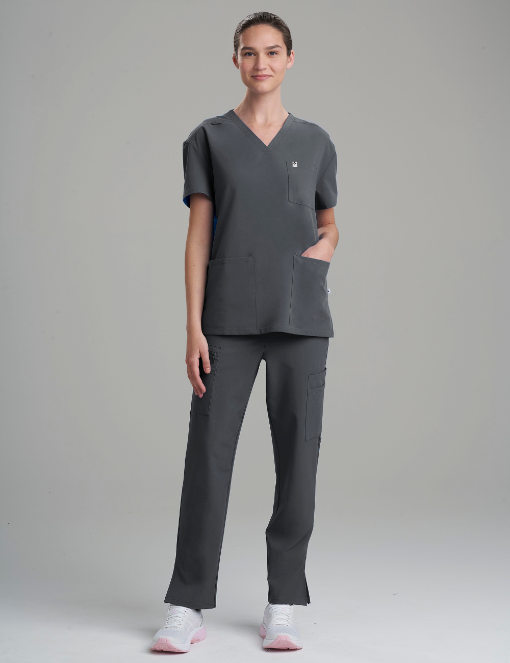 Durable pewter V-neck scrub top for women, offering comfort and utility in professional settings