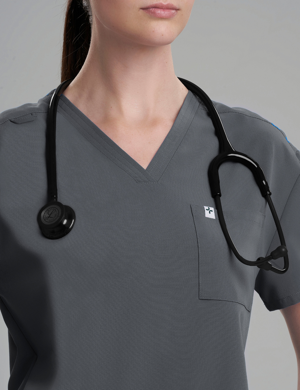Pewter women's V-neck scrub top with three pockets, designed for functionality and style