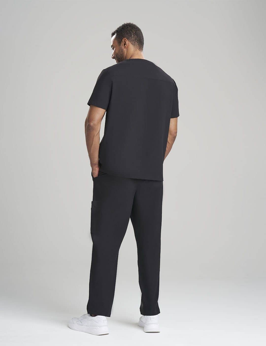 Functional black men&#39;s scrub top, crafted with a V-neck cut and multiple storage options