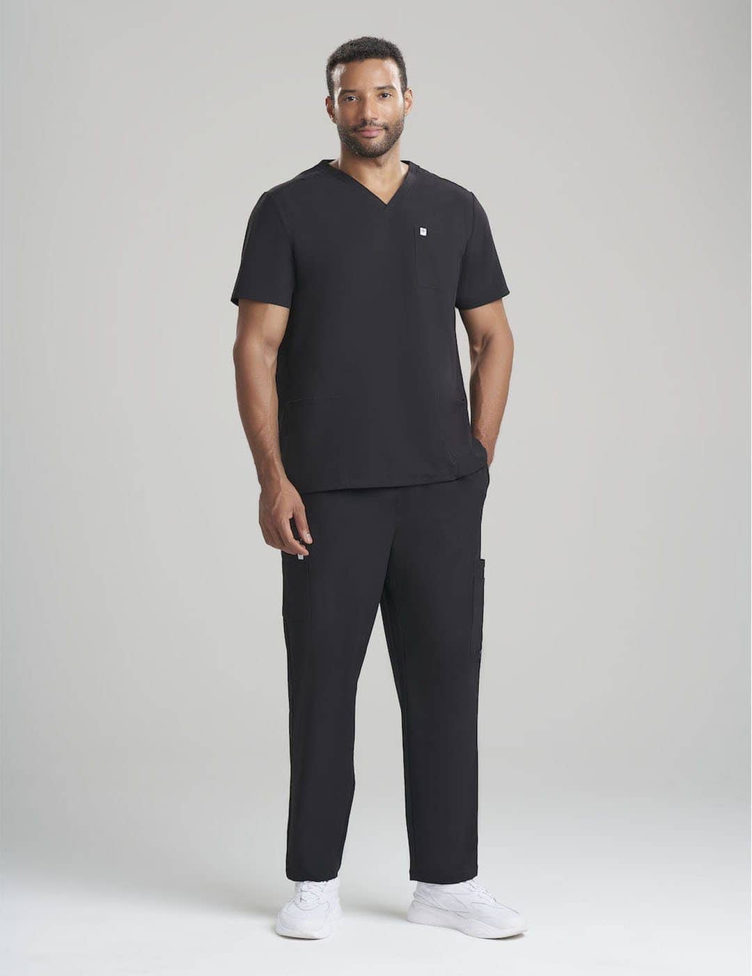 Stylish black scrub top for men, combining a three-pocket design with a modern fit