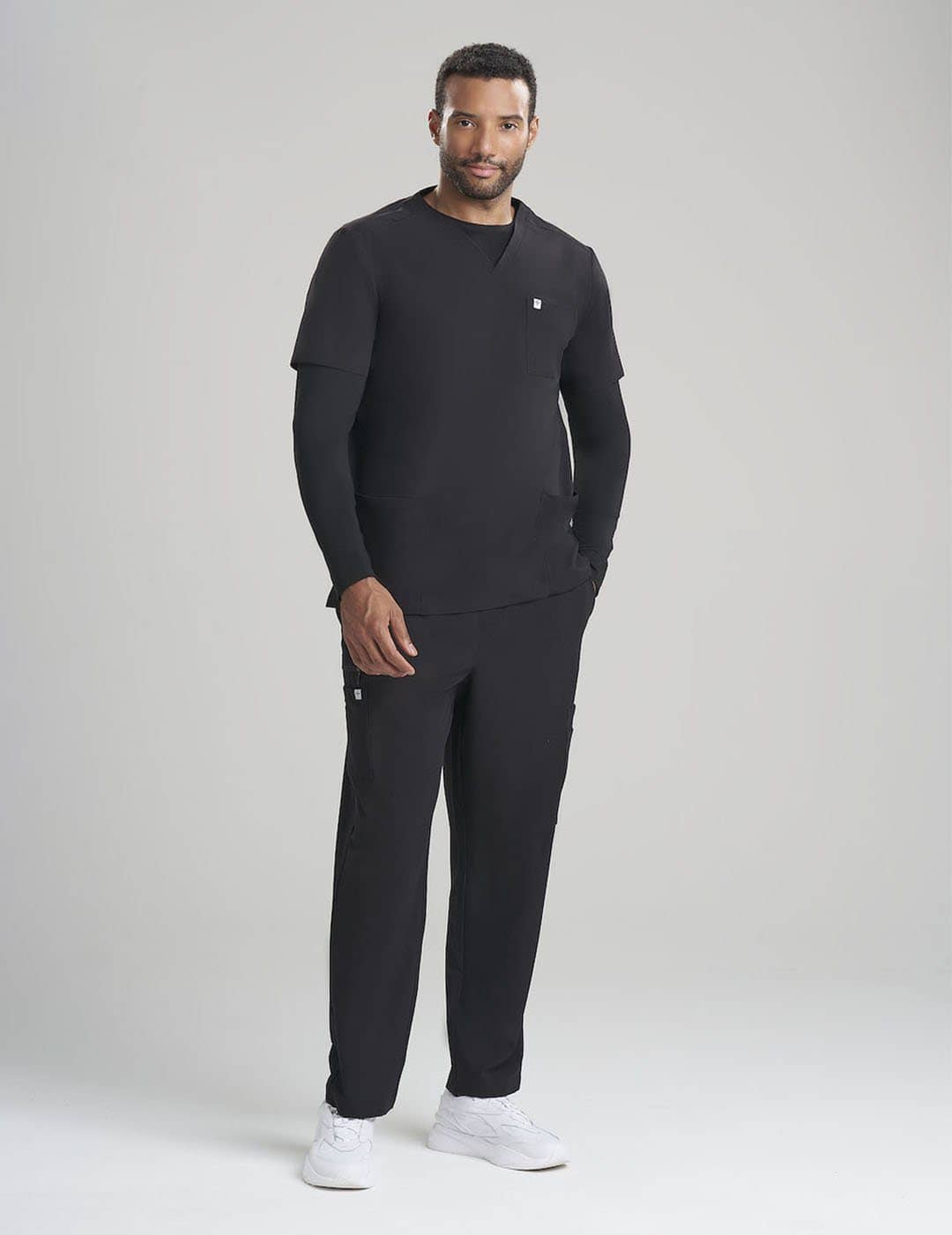 Professional men&#39;s scrub top in black, offering a timeless V-neck design and three practical pockets
