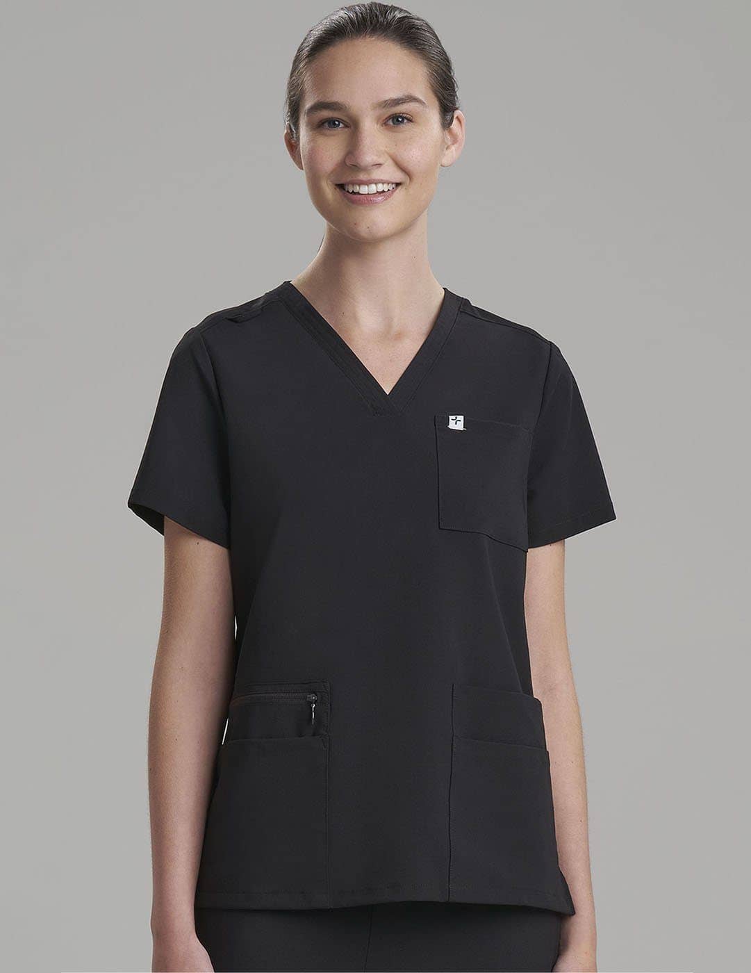 Functional V-neck scrub top in royal blue, designed with six pockets for easy access to essentials. Model is wearing size X-Small