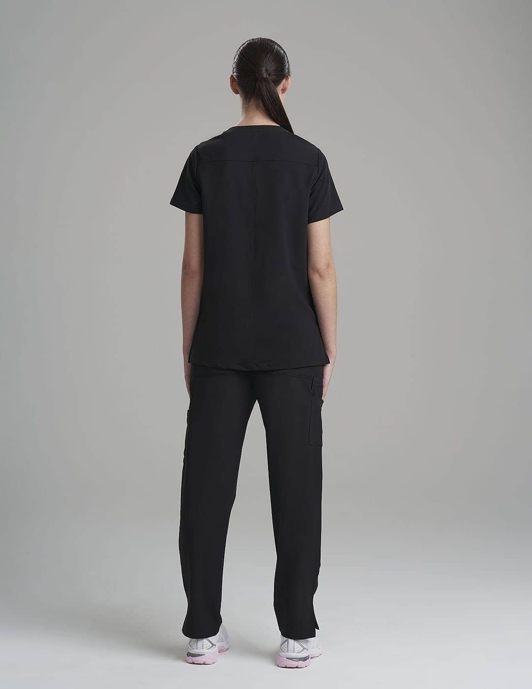 Stylish and durable royal blue scrub top for women, featuring six pockets for everyday needs.