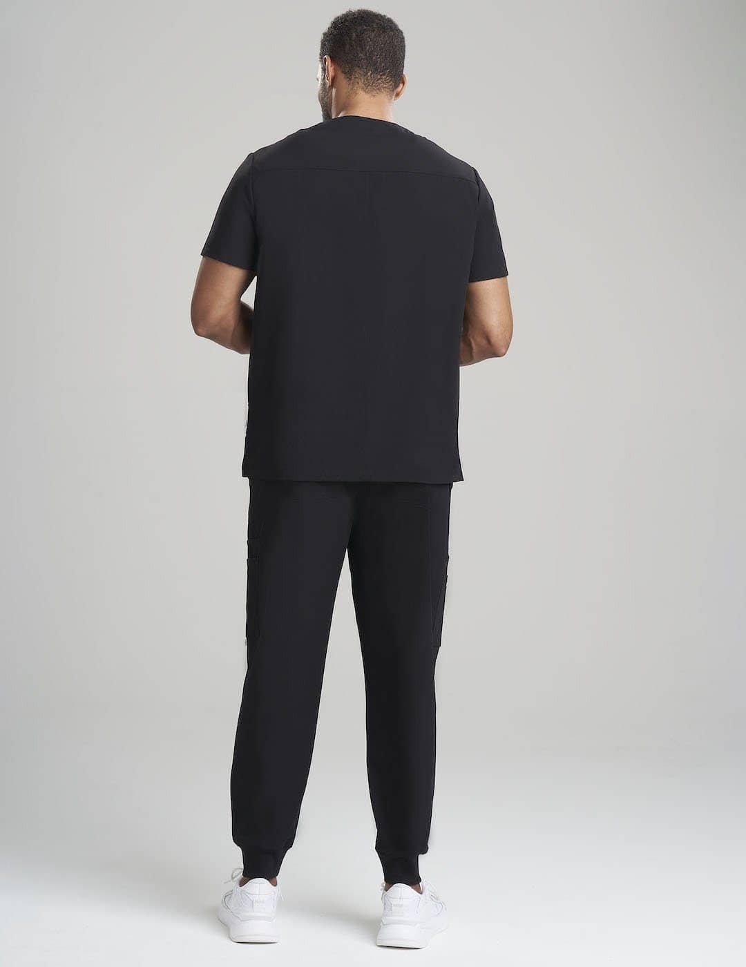Durable black V-neck scrub top for men, crafted for comfort and utility in professional environments