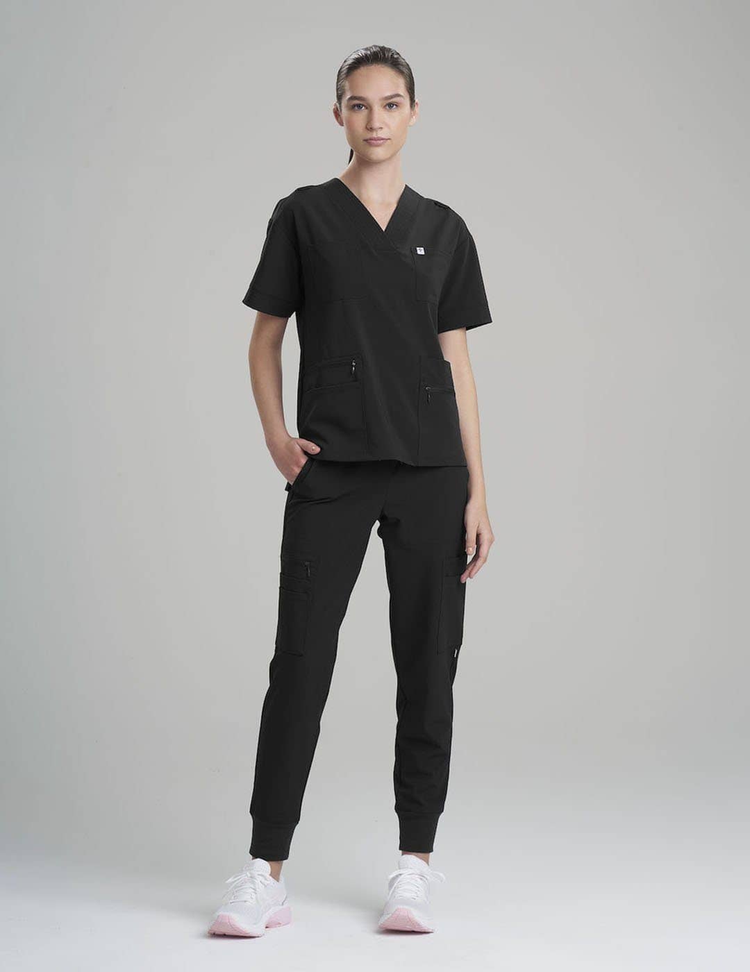 Women's 8-pocket scrub top in ceil, providing professional appeal with practical storage.