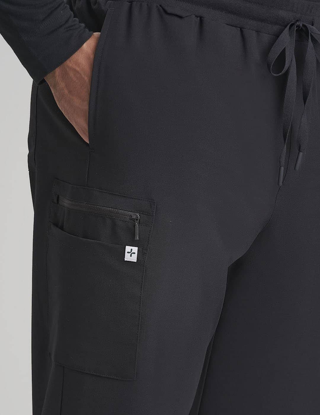 Classic Black Men's 7-Pocket Straight Leg Scrub Pants by Care+Wear, designed for durability, comfort, and plenty of pockets. Model is wearing size Large