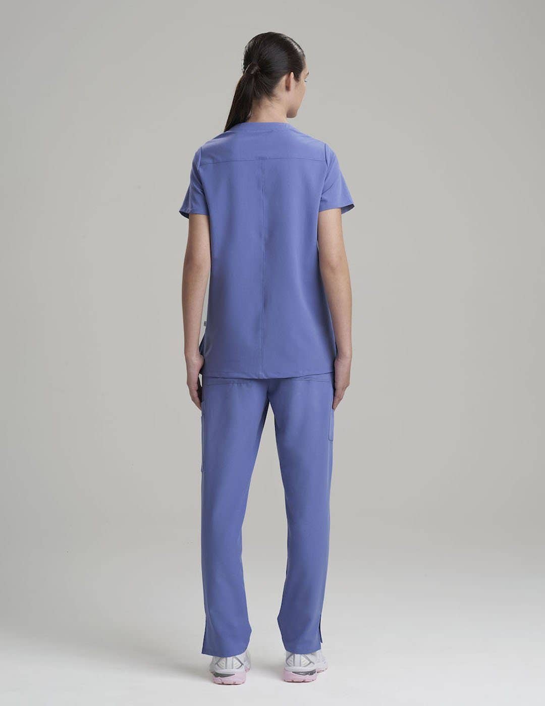 Stylish women's scrub top in ceil, combining a sleek V-neck design with ample pocket space.
