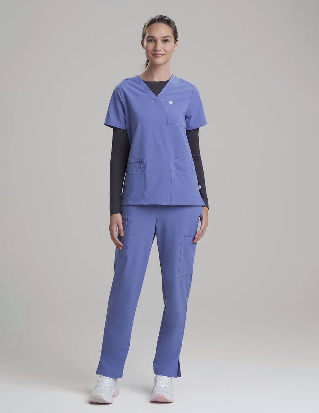 Durable ceil V-neck scrub top for women, crafted with six pockets for organized storage.