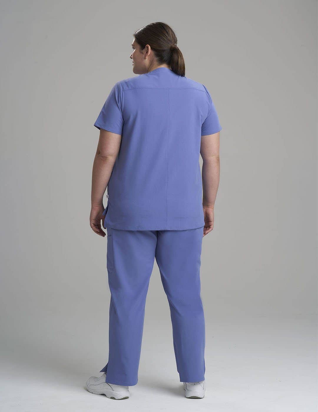 Women's professional scrub top in ceil, featuring six functional pockets for everyday use.
