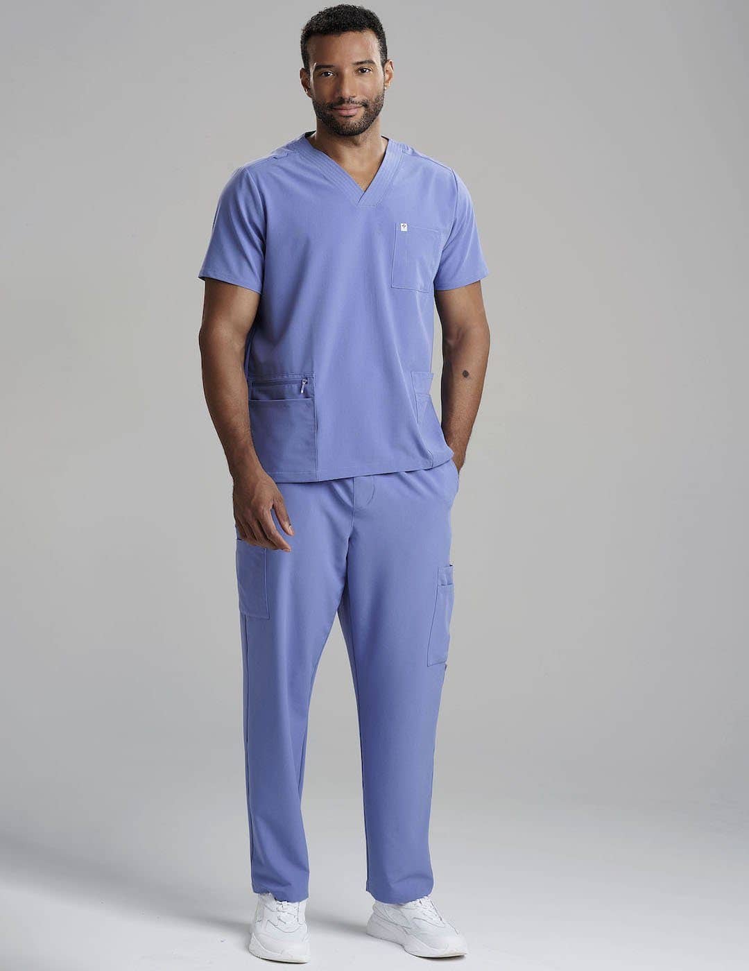 Men's scrub top in ceil blue, featuring a sleek V-neck design and multiple pockets for utility