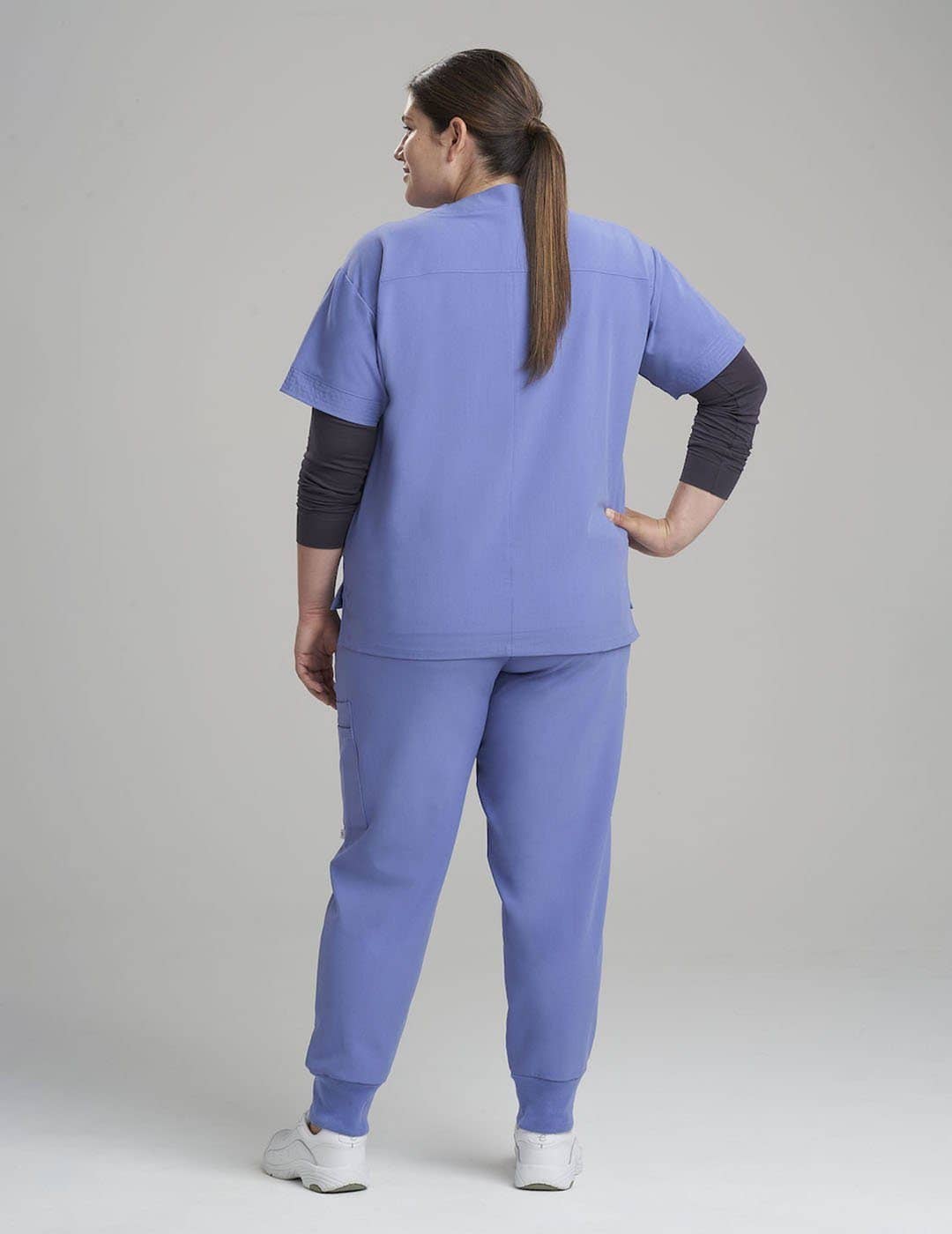 Women's professional V-neck scrub top in ceil, offering plenty of storage with eight practical pockets.