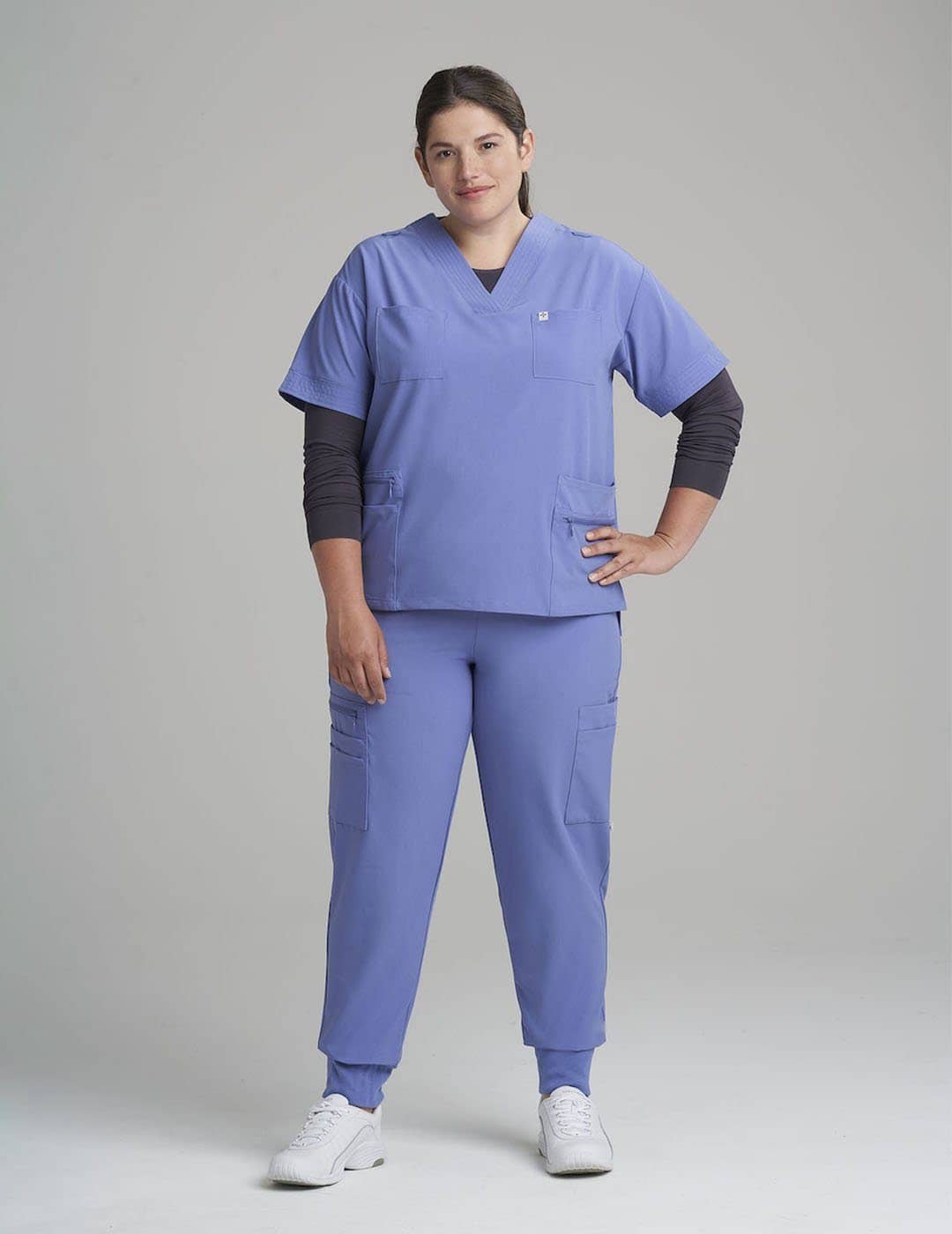 Comfortable ceil women's scrub top with eight pockets, ideal for efficient organization. Model is wearing size Large