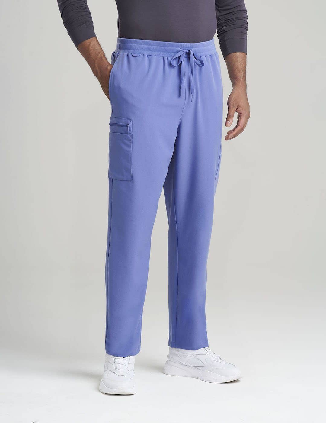 Ceil Men&#39;s 7-Pocket Straight Leg Scrub Pants by Care+Wear, combining a light shade with practical design for medical professionals. Model is wearing size Large