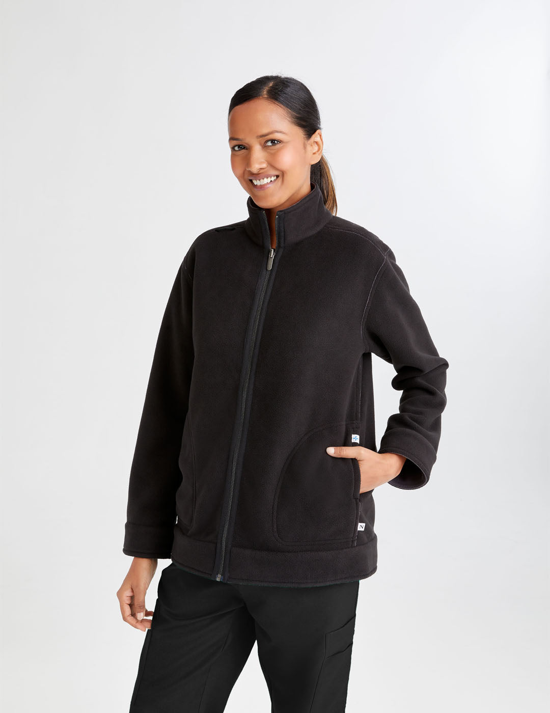 Care+Wear Women's Fleece Jacket in Black/Gray, offering warmth and comfort with a stylish two-tone design for healthcare workers. Model is wearing size Medium