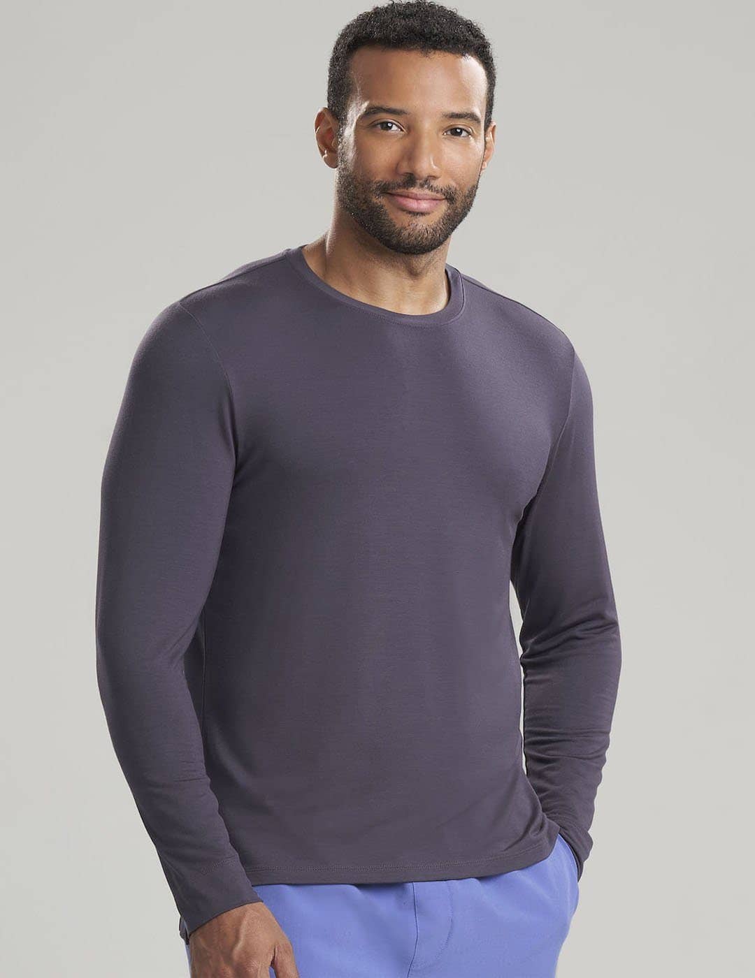 Care+Wear Men's Long Sleeve Underscrub Shirt in Gray, providing a neutral, professional base layer for medical uniforms. Model is wearing size Large