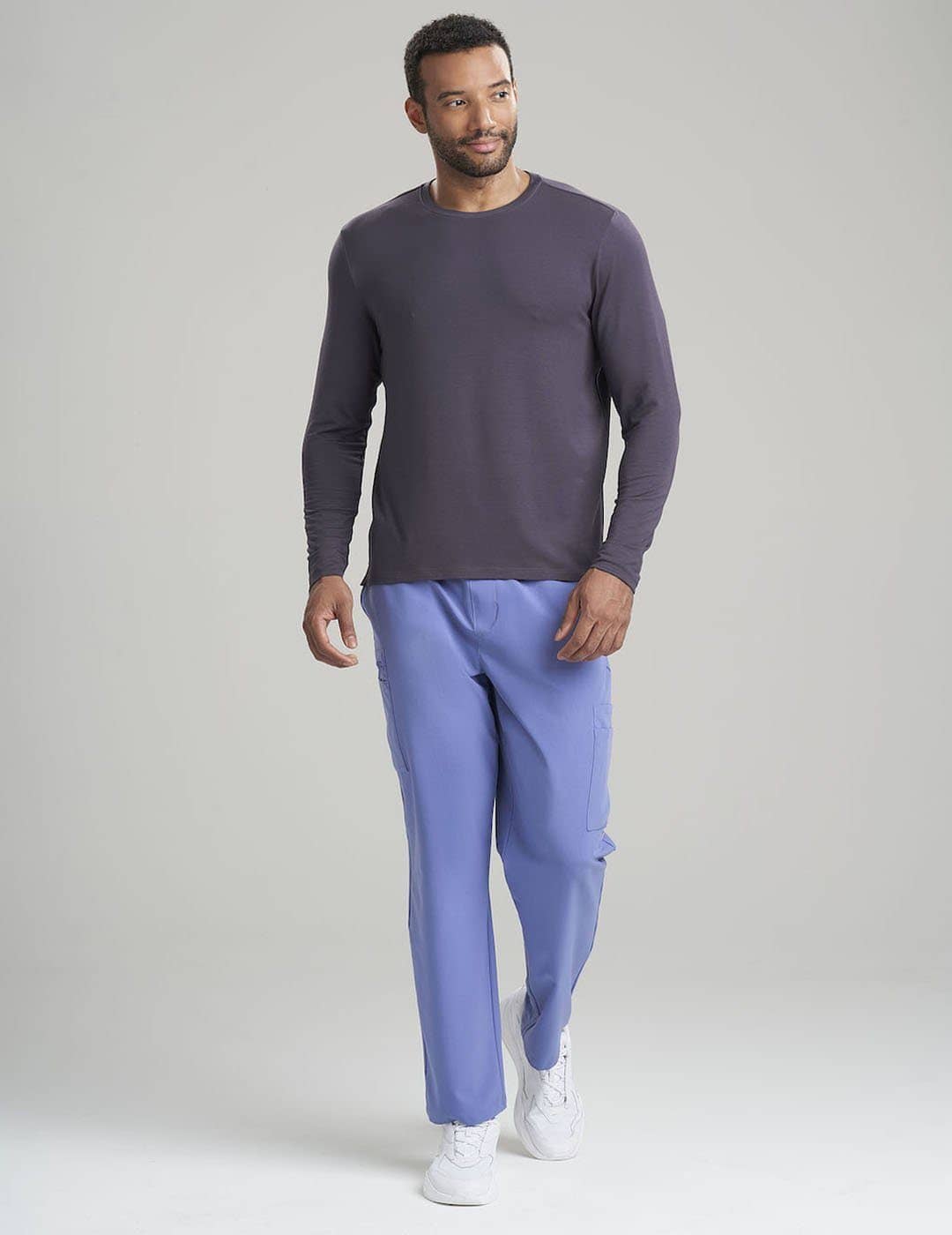 Care+Wear Men's Long Sleeve Underscrub Shirt in Gray, providing a neutral, professional base layer for medical uniforms. Model is wearing size Large