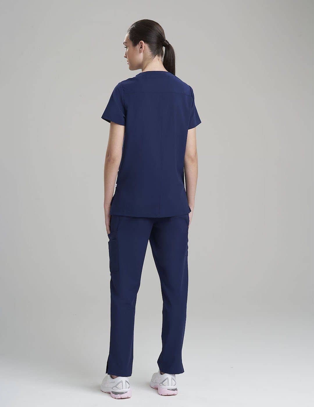 Professional scrub top in royal blue, featuring six functional pockets for organized storage.