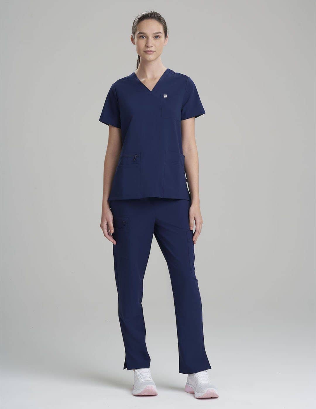 Comfortable royal blue women's V-neck scrub top with six pockets, ideal for busy shifts.