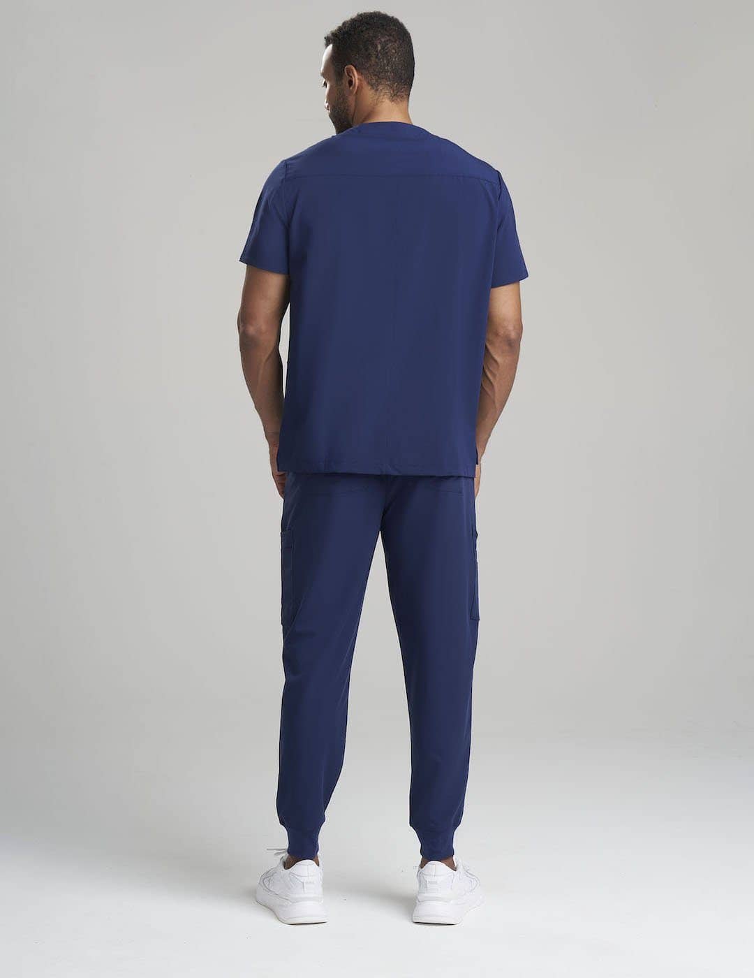 Durable navy men’s scrub pants featuring a functional seven-pocket design, crafted by Care+Wear x N Natori
