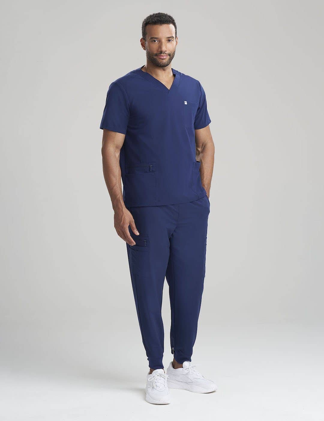 Men’s 7-pocket scrub pants in navy, offering comfort and practicality for professional settings