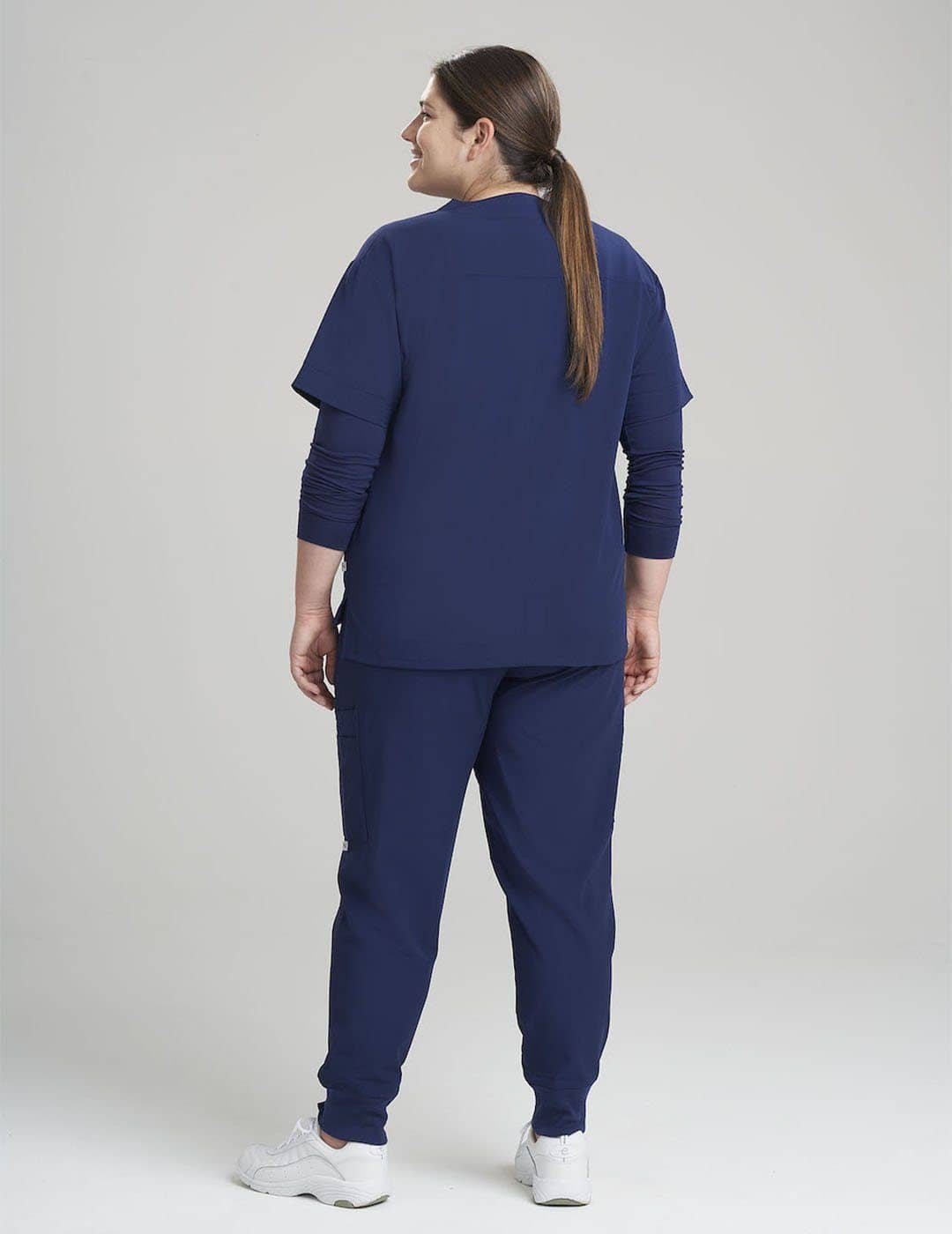 Comfortable royal blue V-neck scrub top for women, ideal for busy healthcare settings with eight pockets.