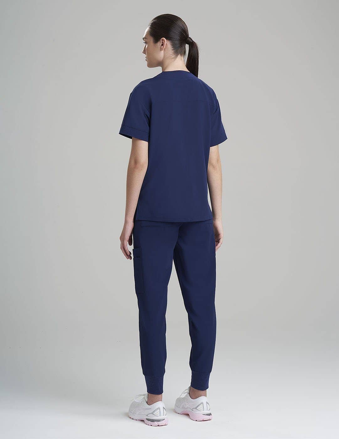 Versatile royal blue V-neck scrub top for women, featuring eight practical pockets for storage.