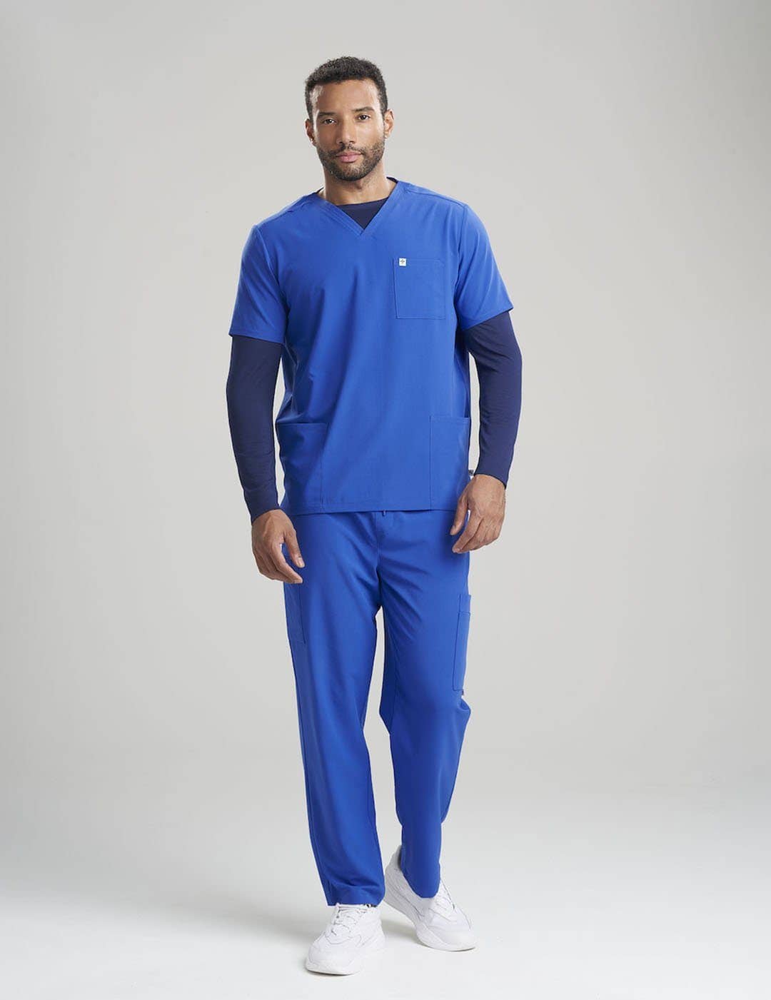 Stylish and functional royal blue scrub top for men, featuring a modern fit and three pockets