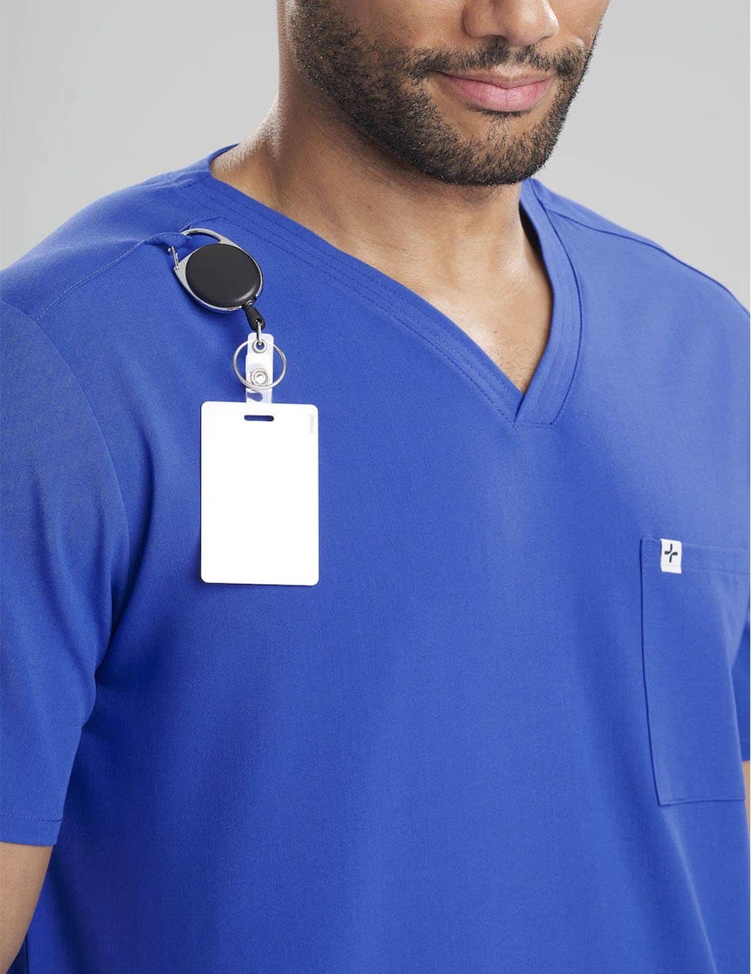 Care+Wear Men's 3-Pocket V-Neck Scrub Top in Royal Blue, featuring a bold color and multiple pockets for convenience during long shifts. Model is wearing size Large