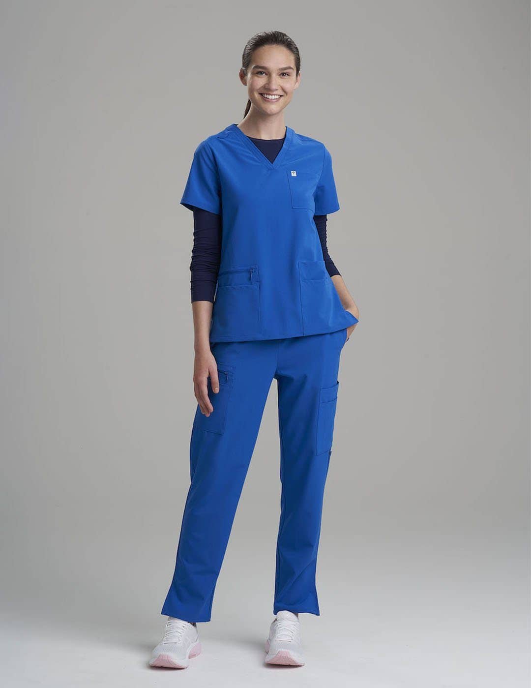 Women's scrub top in ceil, featuring six pockets and a comfortable V-neck cut for medical settings.