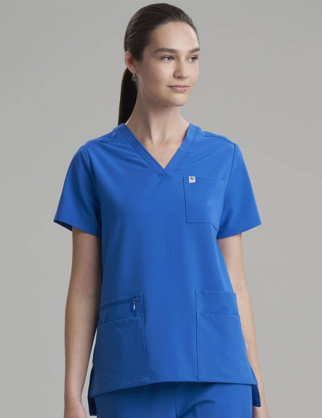 Ceil women's scrub top with six pockets, blending style and functionality for medical professionals. Model is wearing size X-Small