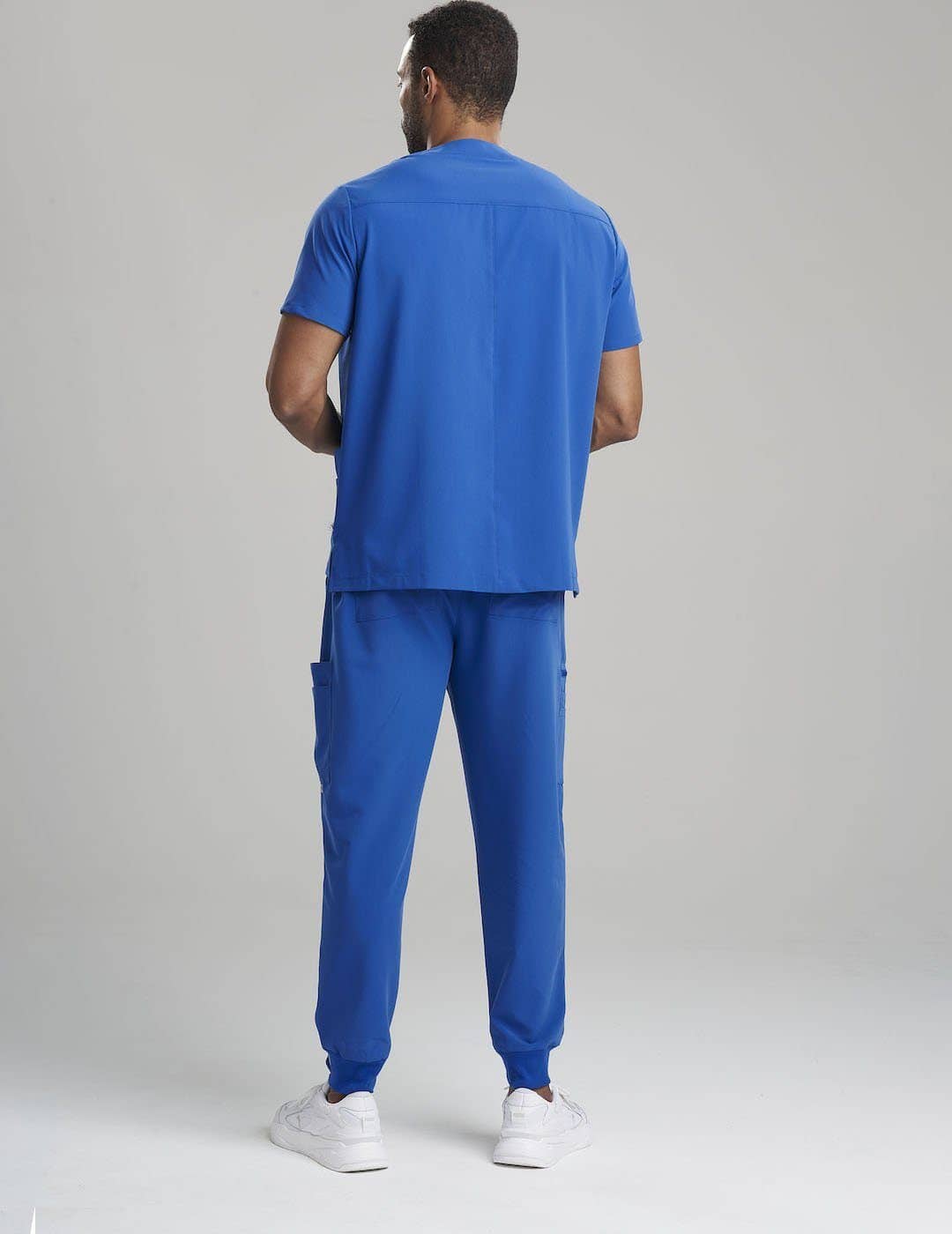 Durable royal blue V-neck scrub top for men, crafted for comfort and utility in professional settings