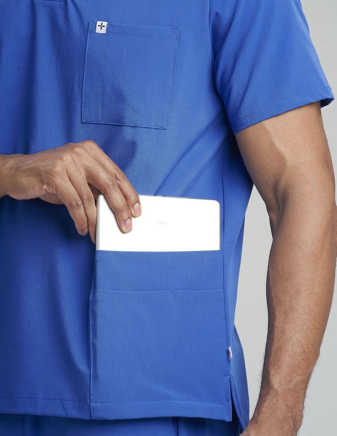Royal blue men&#39;s V-neck scrub top with seven pockets, designed for style and practicality